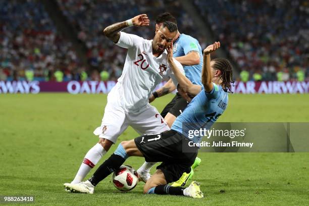 Ricardo Quaresma of Portugal is tackled by Diego Laxalt and Cristian Rodriguez of Uruguay during the 2018 FIFA World Cup Russia Round of 16 match...