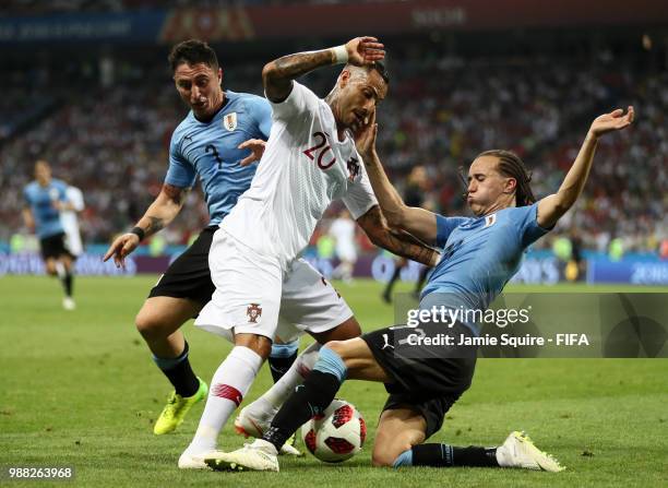 Ricardo Quaresma of Portugal is tackled by Diego Laxalt and Cristian Rodriguez of Uruguay during the 2018 FIFA World Cup Russia Round of 16 match...