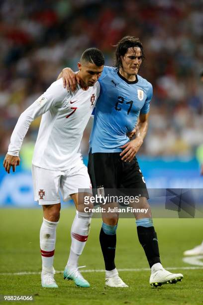 Cristiano Ronaldo of Portugal helps Edinson Cavani of Uruguay off the pitch after he gets injured during the 2018 FIFA World Cup Russia Round of 16...