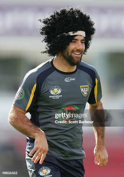 Cameron Smith of the Kangaroos runs as he wears a wig during an Australian ARL Kangaroos training session at Visy Park on May 4, 2010 in Melbourne,...