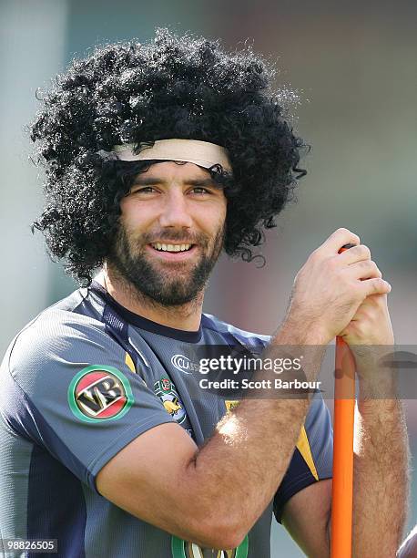 Cameron Smith of the Kangaroos looks on as he wears a wig during an Australian ARL Kangaroos training session at Visy Park on May 4, 2010 in...