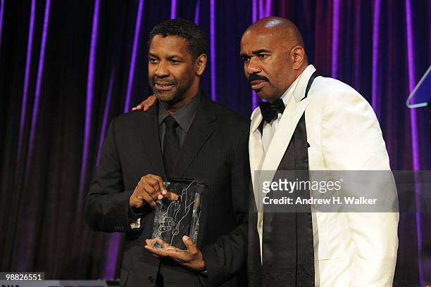 Actor Denzel Washington and host Steve Harvey embrace on stage during the New York Gala benefiting The Steve Harvey Foundation at Cipriani, Wall...