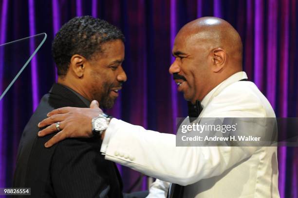 Actor Denzel Washington and host Steve Harvey embrace on stage during the New York Gala benefiting The Steve Harvey Foundation at Cipriani, Wall...