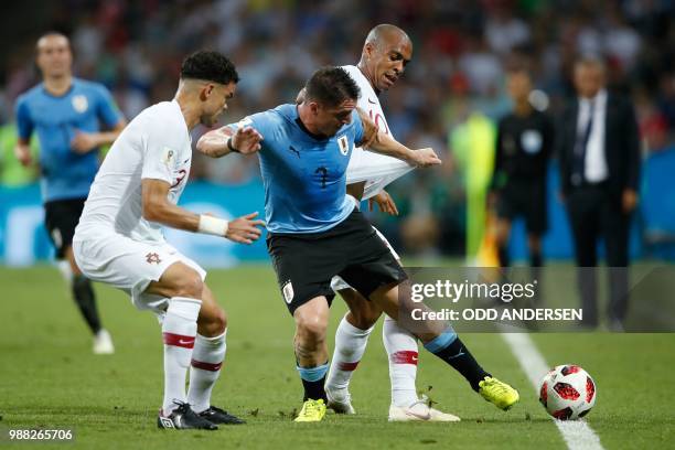 Uruguay's midfielder Cristian Rodriguez is marked by Portugal's defender Pepe during the Russia 2018 World Cup round of 16 football match between...
