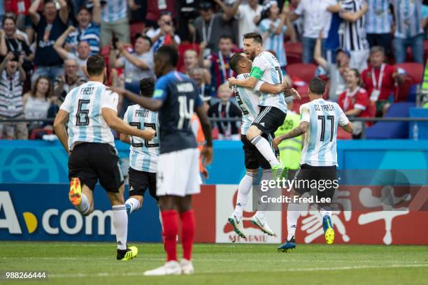 Gabriel Mercado of Argentina celebrates after scoring his team's second goal with team mates Lionel Messi and Angel Di Maria during the 2018 FIFA...