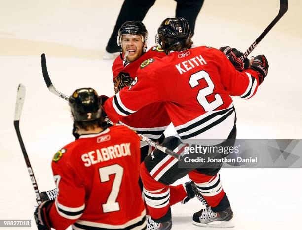 Brent Seabrook of the Chicago Blackhawks skates up as teammate Duncan Keith moves to hug Kris Versteeg after a 3rd period goal against the Vancouver...