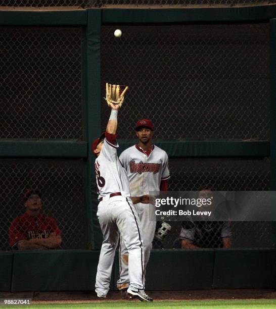 Left fielder Gerardo Parra of the Arizona Diamondbacks makes a catch as he calls of center fielder Chris Young against the Houston Astros at Minute...