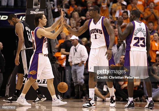 Steve Nash of the Phoenix Suns high-fives teammate Amar'e Stoudemire after scoring against the San Antonio Spurs during Game One of the Western...