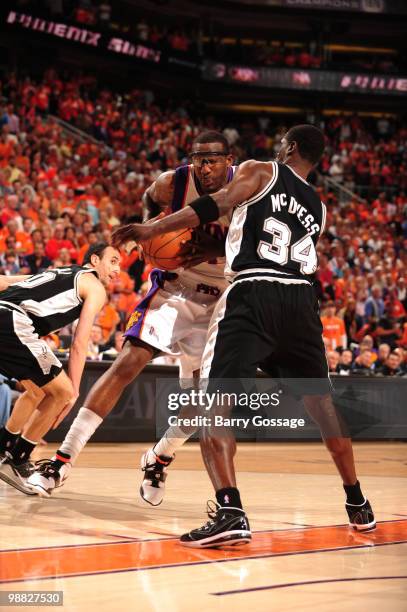 Amare Stoudemire of the Phoenix Suns drives against Antonio McDyess of the San Antonio Spurs in Game One of the Western Conference Semifinals during...