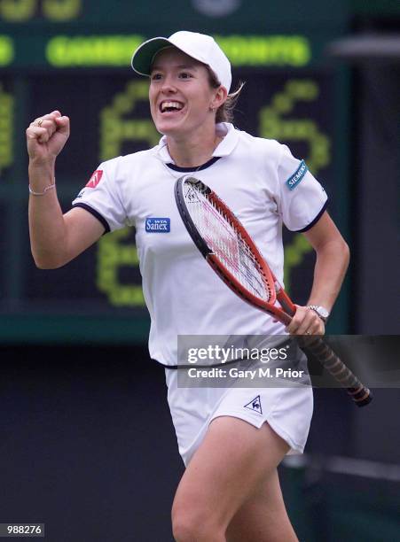 Justine Henin of Belgium celebrates his victory over Lisa Raymond of the USA during the women's third round of The All England Lawn Tennis...