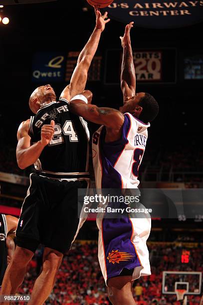 Richard Jefferson of the San Antonio Spurs and Channing Frye of the Phoenix Suns reach for a rebound in Game One of the Western Conference Semifinals...