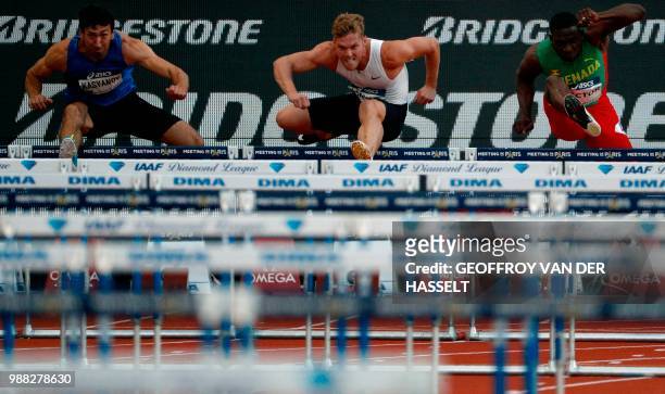 France's Kevin Mayer competes against Ukraine's Oleksiy Kasyanov and Grenada's Lindon Victor in the 110 metres men's hurdles - triathlon event during...