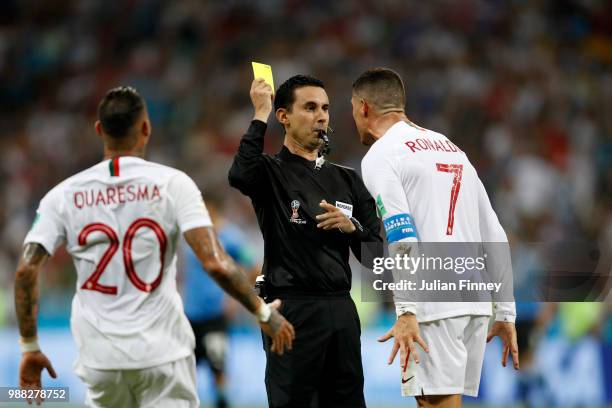 Cristiano Ronaldo of Portugal is shown a yellow card by referee Cesar Ramos during the 2018 FIFA World Cup Russia Round of 16 match between Uruguay...