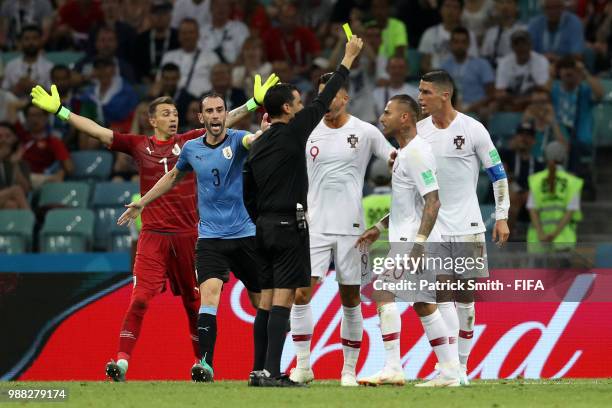 Cristiano Ronaldo of Portugal is shown a yellow card by referee Cesar Ramos during the 2018 FIFA World Cup Russia Round of 16 match between Uruguay...