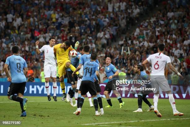 Rui Patricio of Portugal competes for a header with Jose Gimenez of Uruguay during the 2018 FIFA World Cup Russia Round of 16 match between Uruguay...