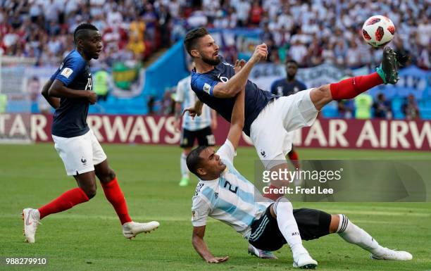 France's forward Olivier Giroud vies for the ball with Argentina's defender Gabriel Mercado during the Russia 2018 World Cup round of 16 football...
