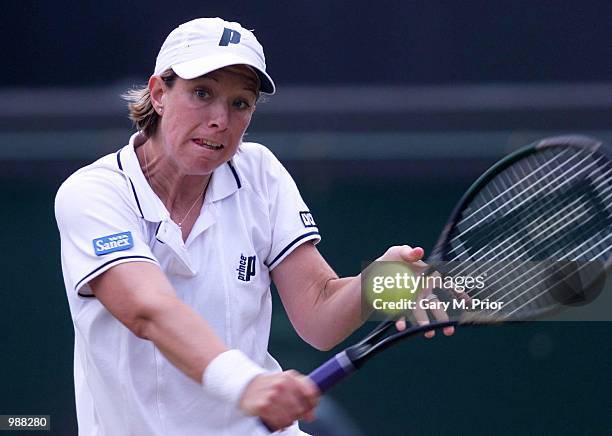 Lisa Raymond of the USA in action against Justine Henin of Belgium during the women's third round of The All England Lawn Tennis Championship at...