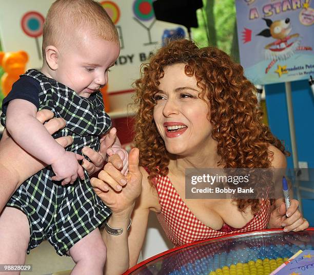 Author Bernadette Peters and fan promote "Stella is a Star" at Dylan's Candy Bar on May 3, 2010 in New York City.