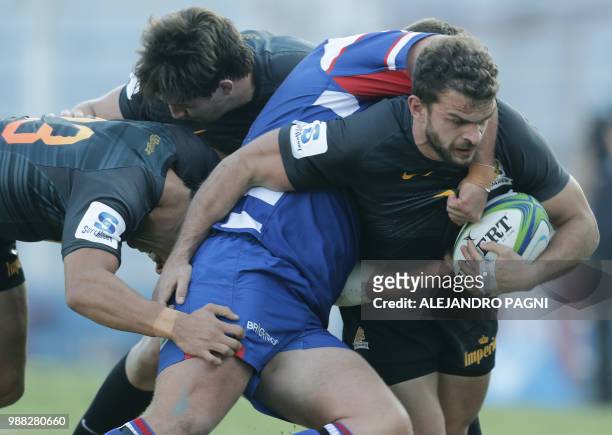 Argentina's Jaguares wing Ramiro Moyano vies for the ball with South Africa's Stormers forward JC Janse van Rensberg during their Super Rugby match...