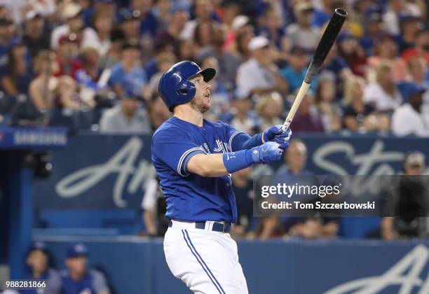 Justin Smoak of the Toronto Blue Jays hits a game-winning solo home run in the ninth inning during MLB game action against the Detroit Tigers at...