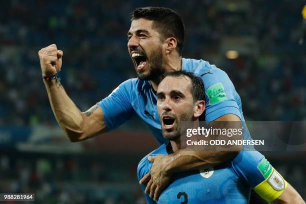 Uruguay's forward Luis Suarez and Uruguay's defender Diego Godin celebrate their win during the Russia 2018 World Cup round of 16 football match...