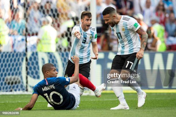 Kylian Mbappe of France is spoken to by Nicolas Otamendi of Argentina during the 2018 FIFA World Cup Russia Round of 16 match between France and...