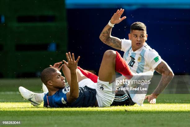 Kylian Mbappe of France reacts after being fouled inside the box by Marcos Rojo of Argentina during the 2018 FIFA World Cup Russia Round of 16 match...