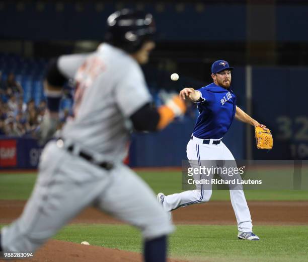 June 30 Toronto Blue Jays relief pitcher Joe Biagini fields the ball and throws out Detroit Tigers designated hitter Victor Martinez in the 8th. The...