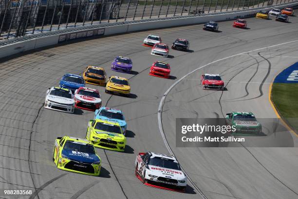 Brandon Jones, driver of the Menards/Jeld-Wen Toyota, and Paul Menard, driver of the Discount Tire Ford, lead a pack of cars during the NASCAR...