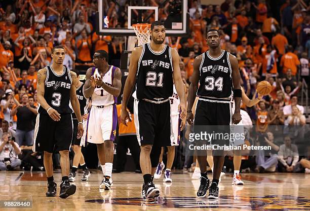 George Hill, Tim Duncan and Antonio McDyess of the San Antonio Spurs react as Amar'e Stoudemire and the Phoenix Suns celebrate in the final moments...