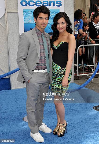 Joe Jonas and Demi Lovato attend the premiere of "Oceans" at the El Capitan Theatre on April 17, 2010 in Hollywood, California.