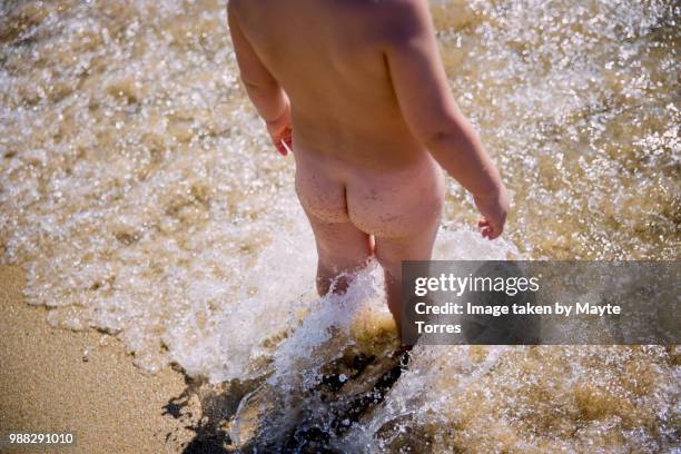 toddler bum in the sea covered in sand - boys bare bum stock pictures, royalty-free photos & images