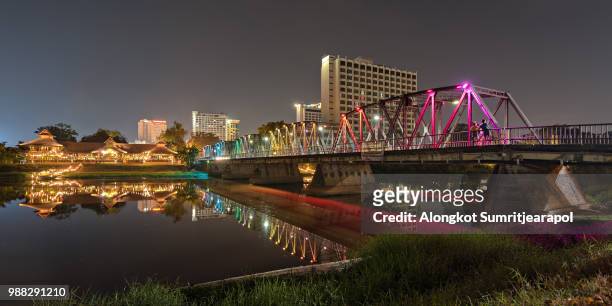 the color of the lights of iron bridge bridge cross ping river chiang mai thailand. (panorama) - iron cross stock pictures, royalty-free photos & images