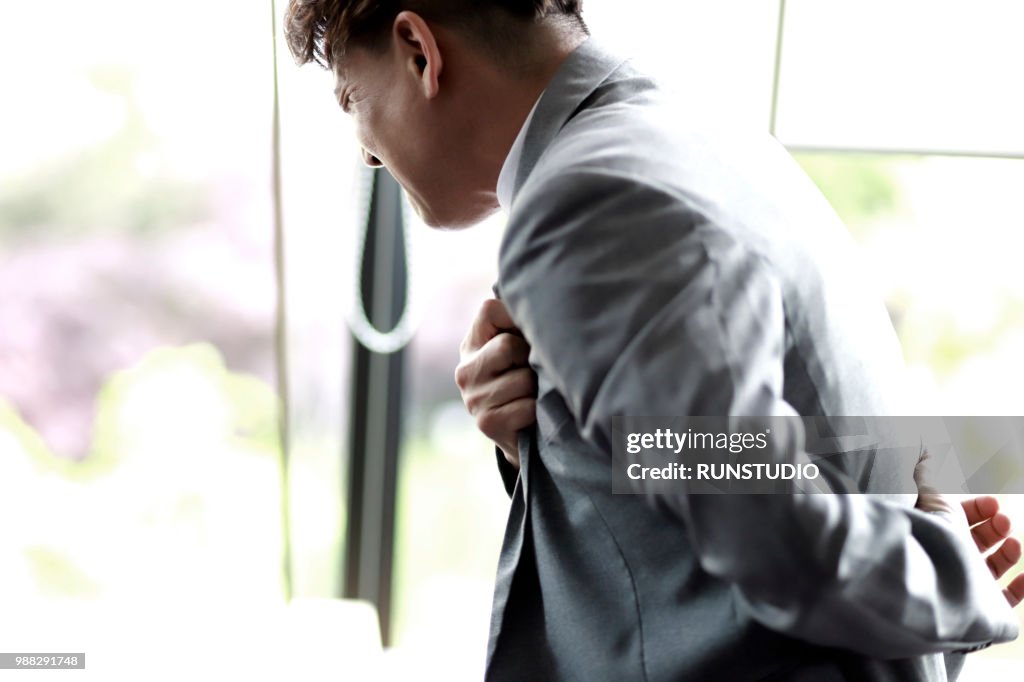 Middle aged businessman with chest pain