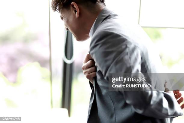 middle aged businessman with chest pain - cardiovascular disease stockfoto's en -beelden