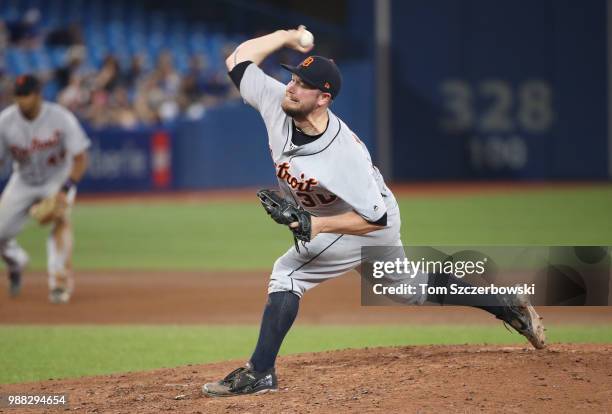 Alex Wilson of the Detroit Tigers delivers a pitch in the eighth inning during MLB game action against the Toronto Blue Jays at Rogers Centre on June...