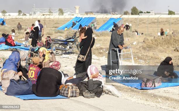 Syrians wait at the border areas near Jordan after they fled from the ongoing military operations by Bashar al-Assad regime and its allies in Syrias...