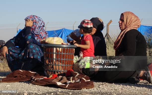 Syrians wait at the border areas near Jordan after they fled from the ongoing military operations by Bashar al-Assad regime and its allies in Syrias...