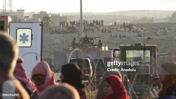 Syrians wait at the border areas near Jordan after they fled from the ongoing military operations by Bashar al-Assad regime and its allies in Syrias...