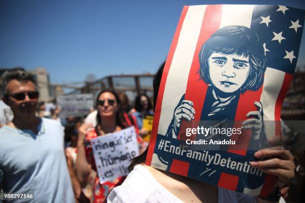 Demonstrators march from Foley Square to Brooklyn Bridge as they take part in "Keep Families Together" march to protest President Donald J. Trump...