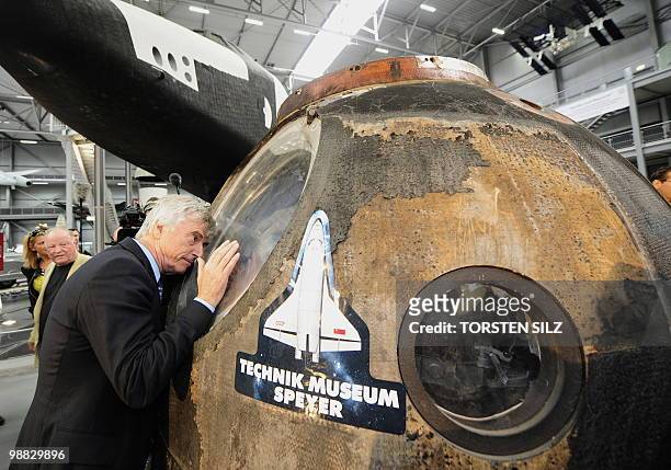 German astronaut Ulf Merbold looks into the reentry module of the Soyuz TM-19 mission, in which he turned back to Earth from the MIR space station in...
