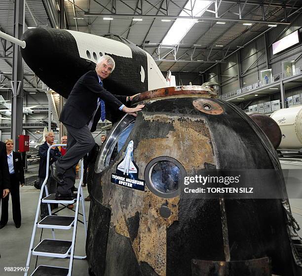 German astronaut Ulf Merbold climbs into the reentry module of the Soyuz TM-19 mission, in which he turned back to Earth from the MIR space station...