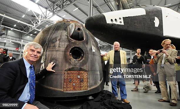 German astronaut Ulf Merbold stands in front of the reentry module of the Soyuz TM-19 mission, in which he turned back to Earth from the MIR space...
