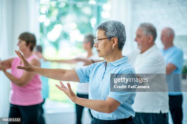 tai chi class - tai chi stock pictures, royalty-free photos & images