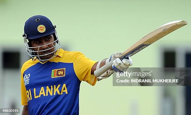 Sri Lankan cricketer Mahela Jayawardene celebrates his century against Zimbabwe during their ICC T20 World Cup match at the Providence Stadium in...
