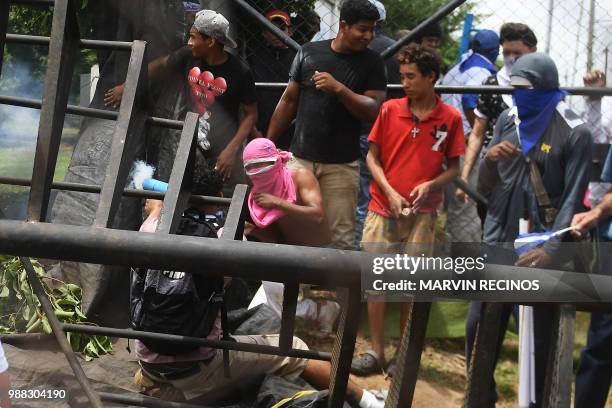 Anti-government protesters take part in clashes within the "Marcha de las Flores" in Managua, on June 30, 2018. - At least six people were shot and...