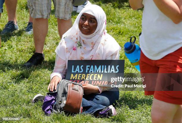 An activist joins MoveOn, National Domestic Workers Alliance, and hundreds of allies at a rally at the White House to tell President Donald Trump and...