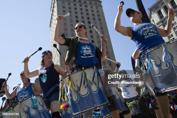 Demonstrators from the Fogo Azul female drumline play during a protest against the Trump administration's policy on separating immigrant families at...