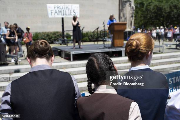 Demonstrators listen to speeches during a protest against the Trump administration's policy on separating immigrant families in the Brooklyn borough...