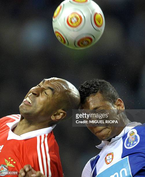 Benfica's Brazilian defense Anderson Silva "Luisao" heads the ball with FC Porto´s midfielder from Colombia Fredy Guarin during their Portuguese...